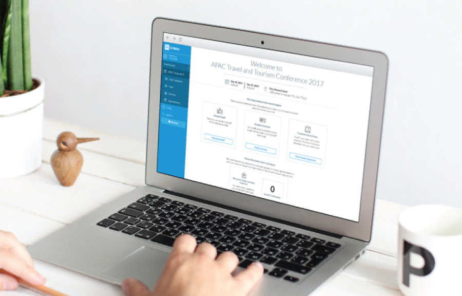 Hands typing on a laptop with a screen showing the APAC Travel and Tourism Conference 2017 website.