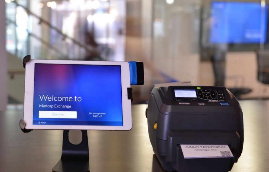 Conference and meeting solutions, such as a tablet and a printer, on a desk in an office.