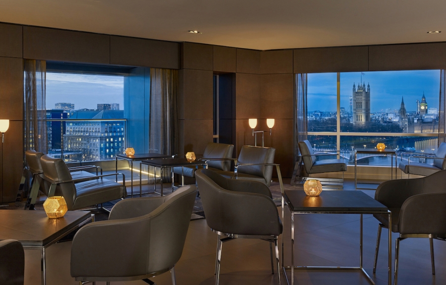 The executive lounge of Park Plaza Westminster Bridge London with a view of Big Ben at dusk.