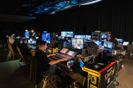 Tech team working in a dimly lit room with lots of monitors and equipment during Cvent CONNECT Europe 2024.