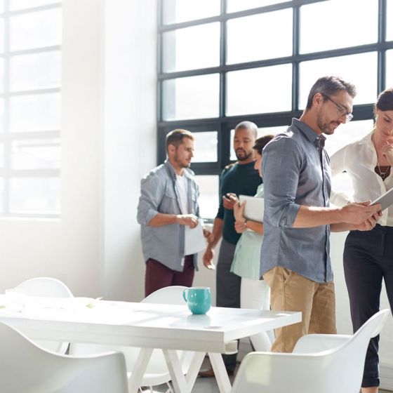 Group of people collaborating in a meeting room at the office.