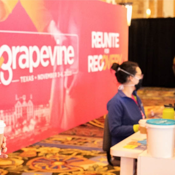 Woman wearing a mask at the check-in table at a WEC Grapevine event.