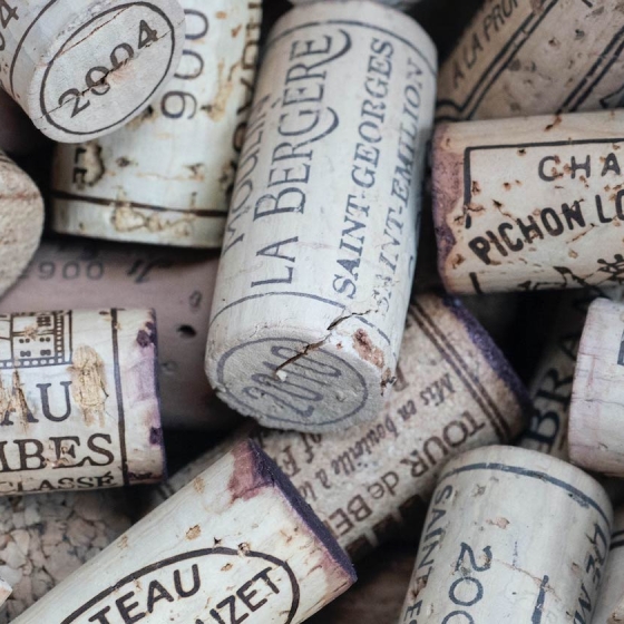 Many different types of wine corks stacked on top of each other from Deutsch Family Wine & Spirits.