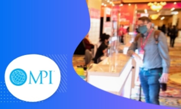 A man wearing a mask stands beside a counter, with the MPI logo on the left side.