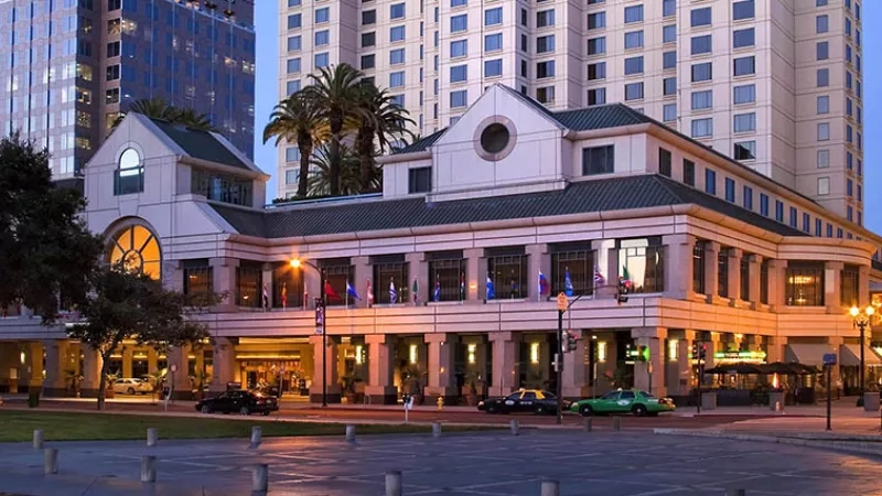 The Westin St. Francis in San Francisco, with flags and a lawn in the foreground.