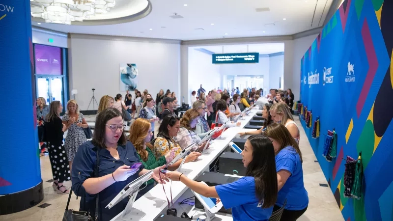 Long lines of people are waiting to be checked in at the MGM Grand by staff members.