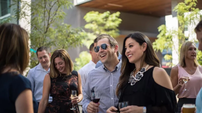 A group of people gather at an outdoor event at the TELUS Spark Science Centre in Calgary.
