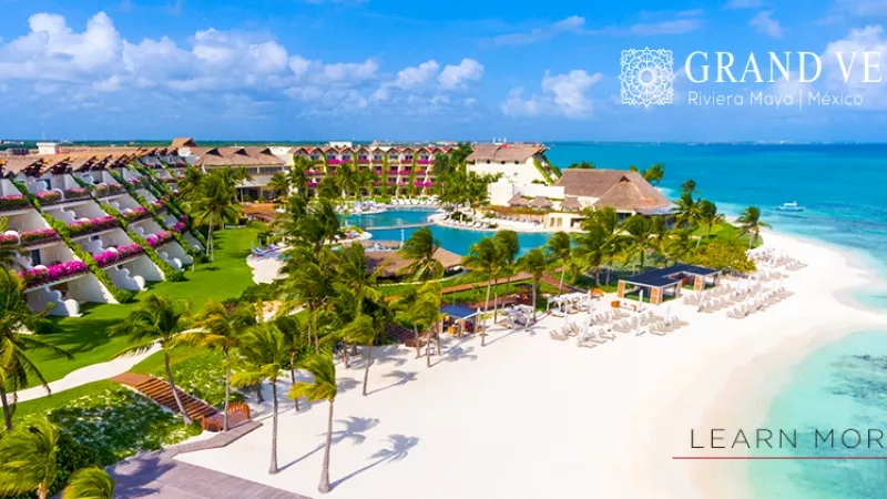A top view of Grand Velas Riviera Maya hotel with a pool, beach, and ocean view.