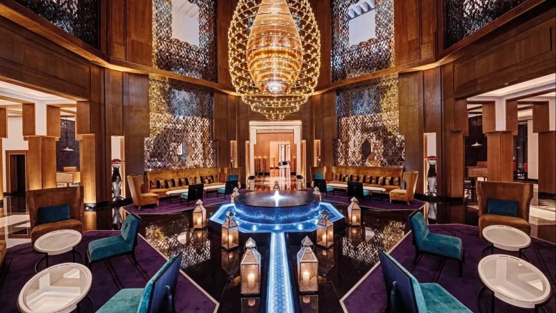 Elegant lounge with a water feature and a large chandelier in the center, creating a luxurious ambiance.