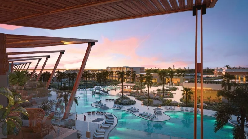An aerial view of the pool area with several lounge chairs and a resort view.