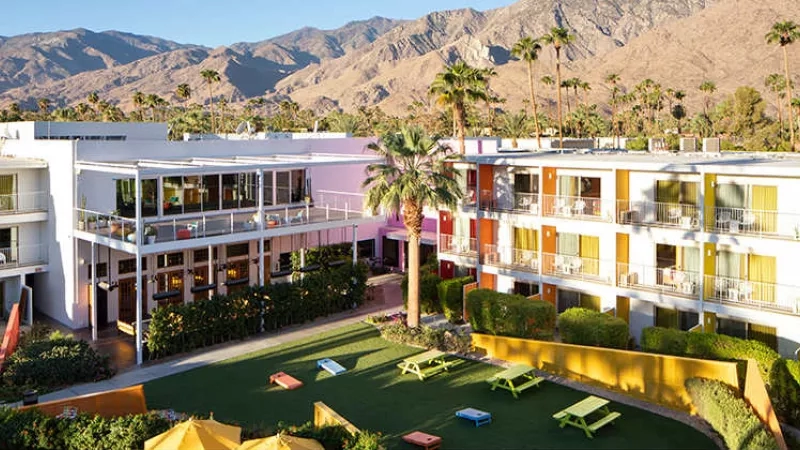 Aerial view of Ace Hotel and Swim Club Palm Springs, with mountains in the background.