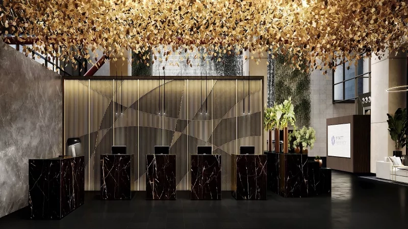 Hyatt Regency Barcelona's reception area, with golden leaves and black marble counters.