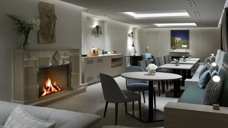 Hyatt Regency Hesperia Madrid's interior featuring modern architecture and an elegant lounge with fireplace and furnishings.