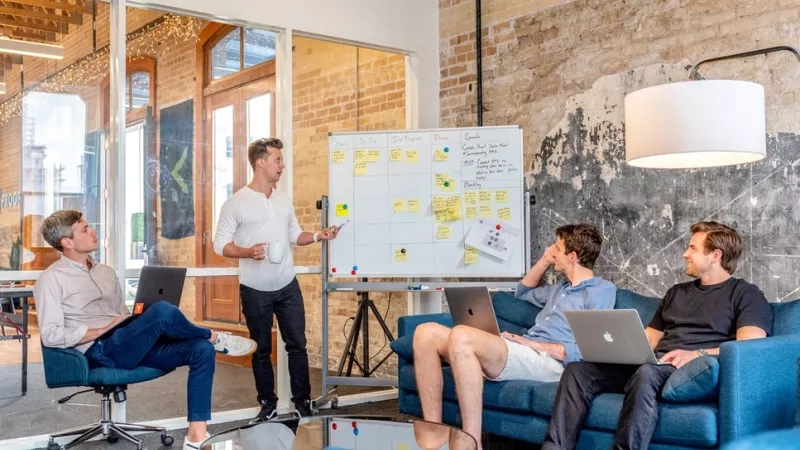 Four people in a meeting in a meeting room at The Mill in London.