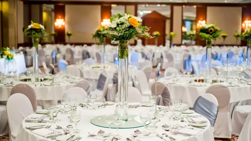 Beautiful wedding hall with white tablecloths and flower centerpieces at the Grand Hyatt Melbourne.
