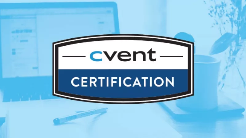 Cvent Certification badge in front of a computer monitor and pen on a desk.