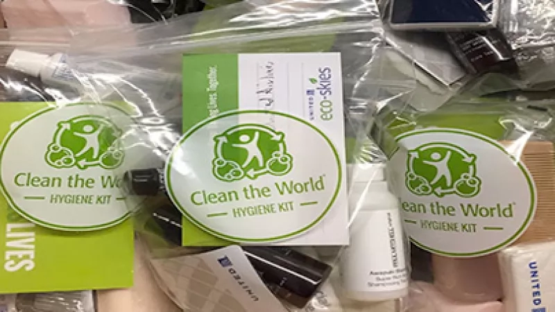 Several hygiene kits with "Clean the World" and "Hygiene Kit" written on them are packaged together.