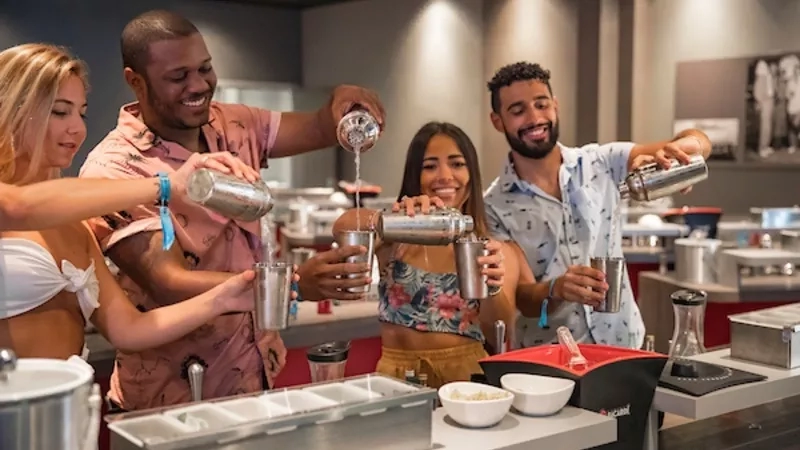 A group of people are having fun while attending a mojito class.