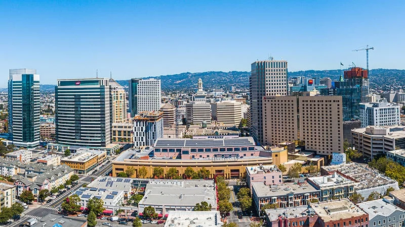 A view of downtown San Jose, California, with buildings, skyscrapers, and the skyline in the distance.