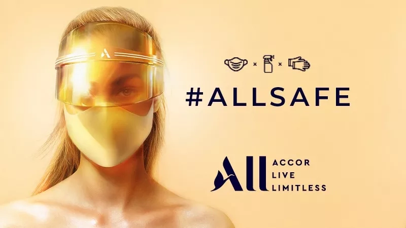 A woman wearing a mask and a visor with the text #ALLSAFE and ACCORD LIVE LIMITLESS.
