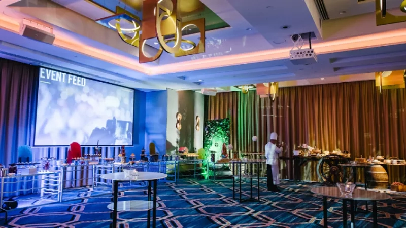 Chef standing in front of the buffet table at the Amora launch event in the ballroom.