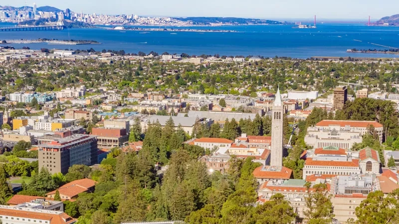 A view of Berkeley with the Campanile in the foreground and the Golden Gate Bridge in the background.