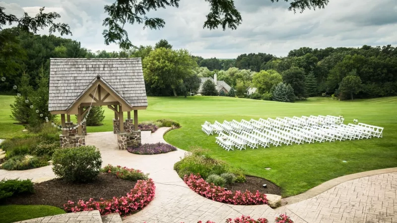 Chairs set up for a wedding ceremony on a golf course at The Club at New Seabury.
