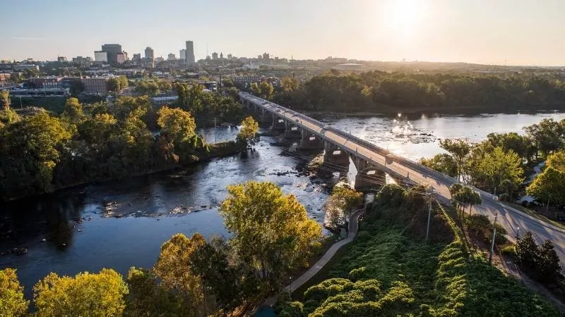 A bridge over the river with the city skyline in the distance during sunset, Richmond, Virginia.