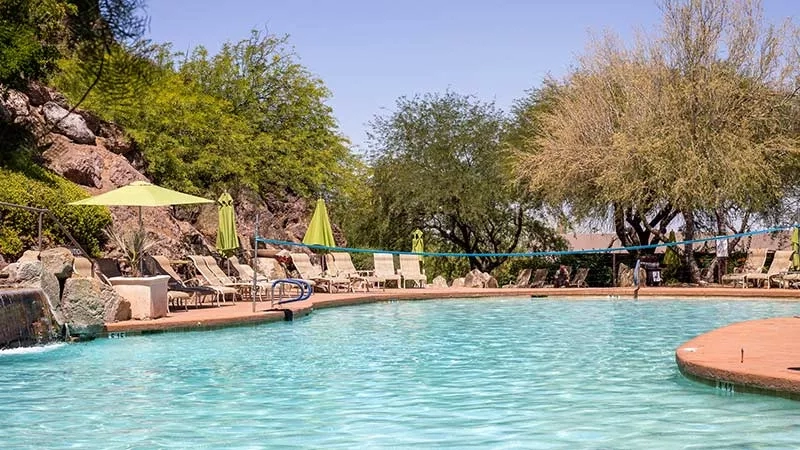Tempe Tourism 800x450 May Feat Blog image showing a swimming pool and trees in the background.