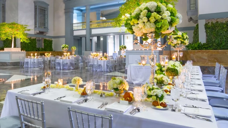 Inside view of a beautiful wedding venue with flowers and decorated tables at The Mansion at Main.
