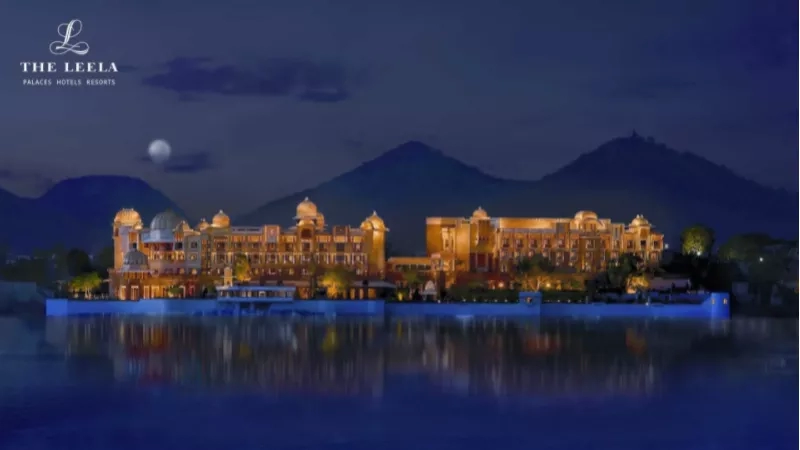 The Leela Palaces and Resorts in Udaipur, Rajasthan, India, with the moon and mountains in the background.