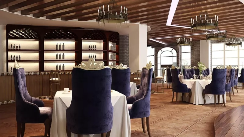 The interior of the restaurant is decorated with chandeliers and tables covered in white cloth.