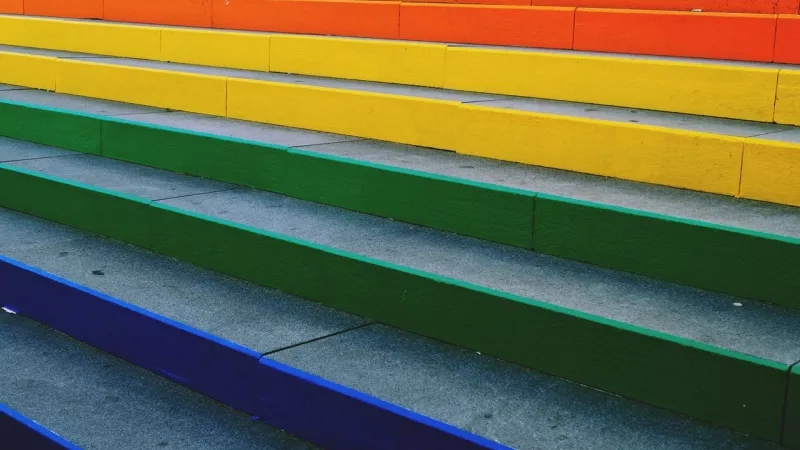 Steps painted in rainbow colors, each step a different color, arranged in a sequence of colors.