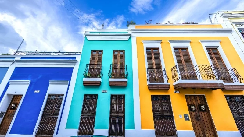 Colorful buildings with balconies and shutters, showcasing vibrant architecture and inviting ambiance.