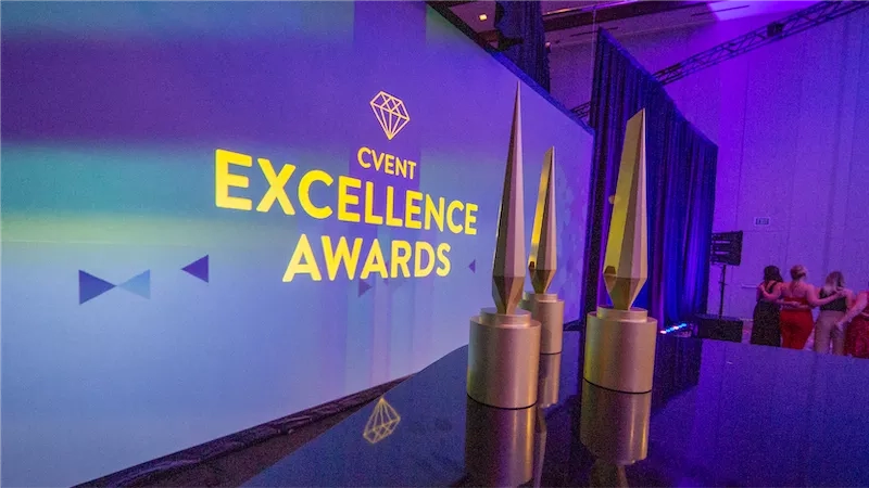 Three golden trophy awards with the text "Cvent Excellence Awards" on a purple background.