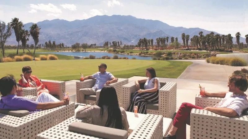 Group of people enjoying cocktails at La Quinta Country Club in California.