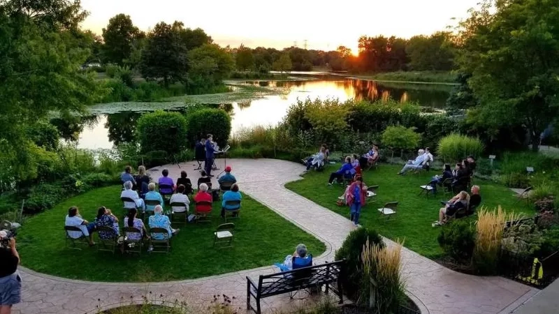Lakeside gathering at Lake Katherine Nature Center, featuring sunset views, lush greenery, and serene ambiance.