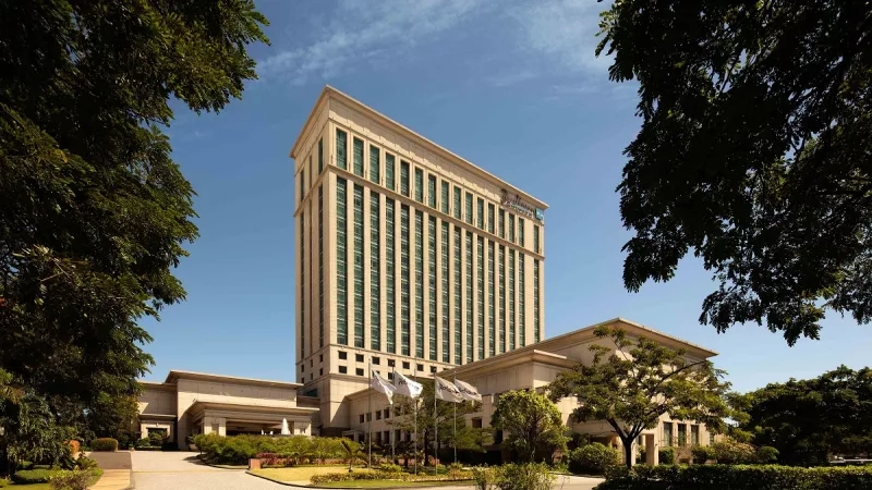 Exterior view of the hotel from the open parking lot during the daytime at Radisson Blu Resort Temple Bay.
