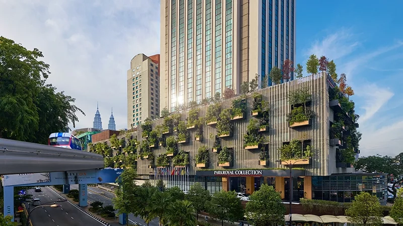 Parkroyal Collection exterior with lush vertical garden, modern architecture, and urban ambiance in Kuala Lumpur.