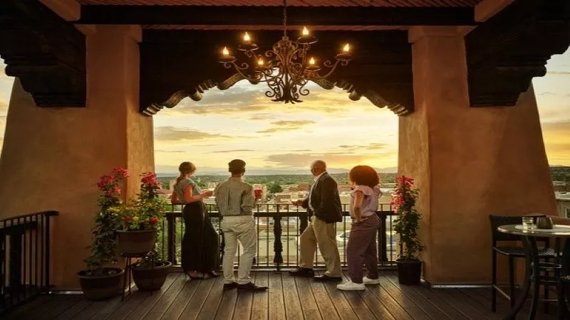 Four guests enjoy a sunset view on the balcony of the Santa Fe Lodge.