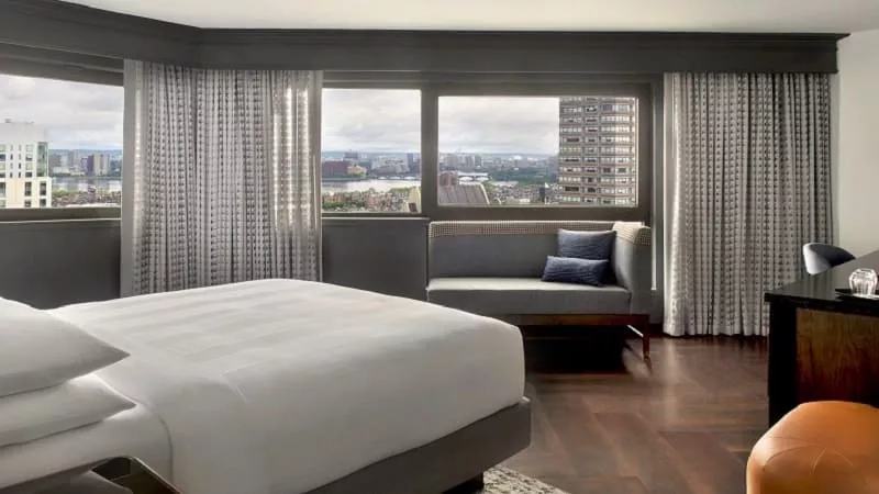 Bedroom with king bed and couch at The Ritz-Carlton, Boston, a Marriott Luxury Hotel.