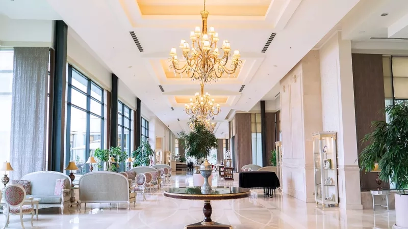 Luxurious five-star hotel lobby with elegant chandeliers, seating, and refined decor for an opulent ambiance.
