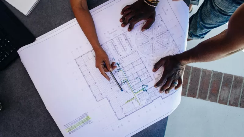 two people look at floor plans