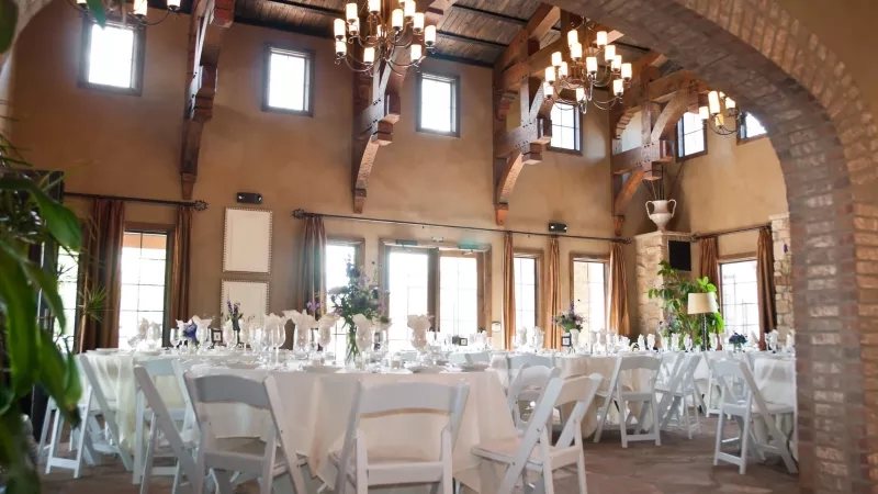 Long banquet tables set up for a special event in a large room at the Stone Crest Venue.