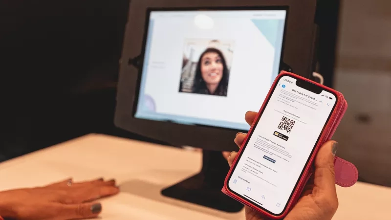 A person scanning a QR code to check in to an event with the mobile app.