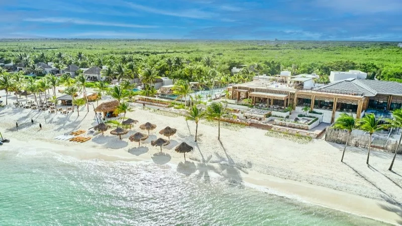 An aerial view of the Fairmont Mayakoba resort with beach, architecture, and landscaping.