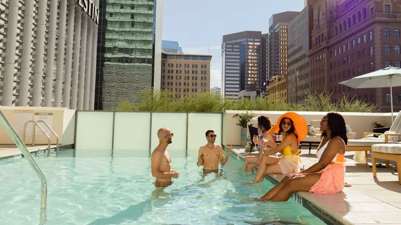 A group of adults enjoy the pool at The Westin Phoenix Downtown.