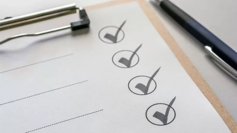 Checklist with clipboard and pen on top, illustrating organization and task management in property management.