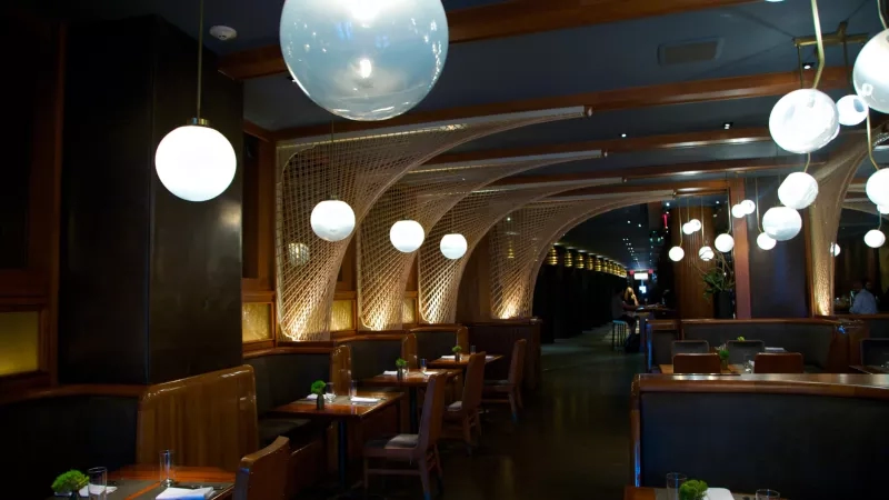 Moody lighting and unique table design in the lounge of the Kimpton Hotel Monaco in Pittsburgh.