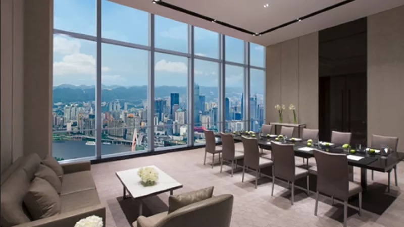Conference room with chairs and desk in front of glass windows with city view in JW Marriott Hotel Shenzhen.